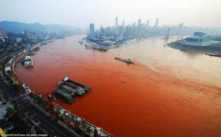 Yangtze River in Chongqing, China turns red from textile waste pollution. Photo courtesy of ChinaFotoPress via Getty Images.