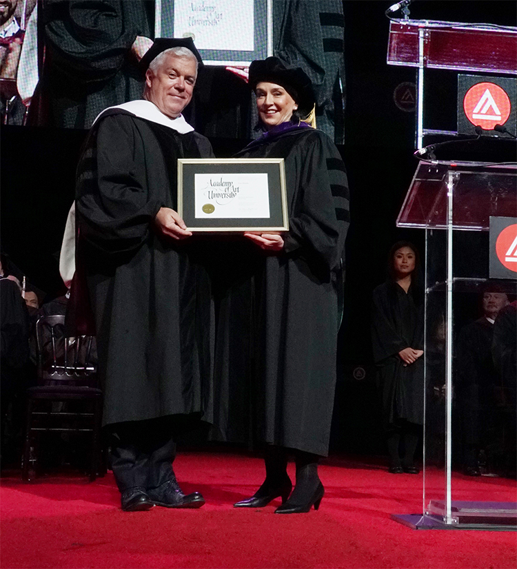 Tim Blanks receiving his honorary Doctorate diploma from President Elisa Stephens at Academy of Art University 2016 Commencement