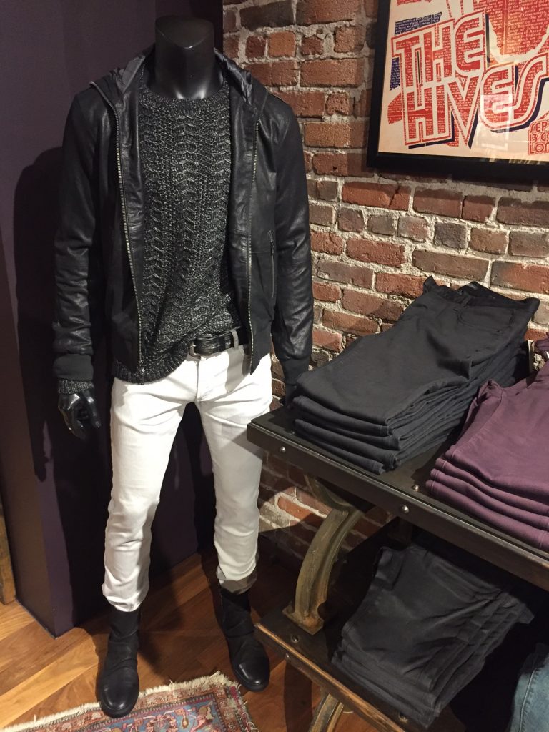 A woolen sweater and leather jacket paired with fitted white denim and leather boots show a true representation of the classic John Varvatos style. Image Source: Fashion school Daily
