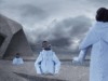 Models in futuristic clothes emerge from the ground